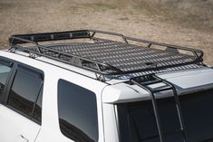 a white truck with a metal rack on the roof