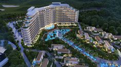 an aerial view of the resort and surrounding area at night, with lights lit up