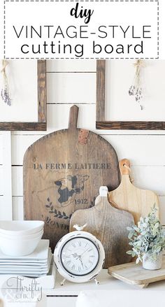 an old cutting board is sitting on a table next to other kitchen utensils