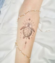 a woman's arm with a tattoo on it and a turtle in the middle