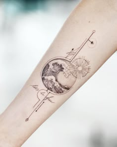 a woman's arm with a tattoo on it and an arrow in the middle