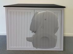 a white cabinet with a bear head on it