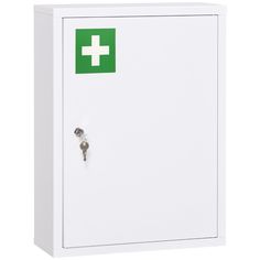 a white medicine cabinet with a green cross on the door and two keys in it