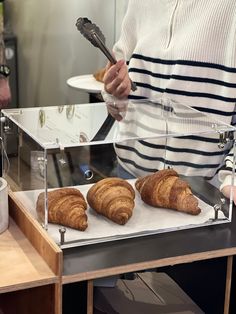 two croissants are being prepared on a counter