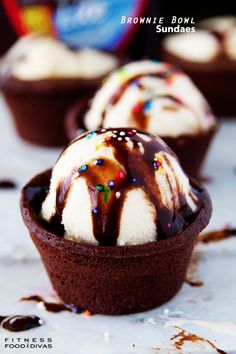 chocolate cupcakes with ice cream drizzled on top and sprinkles