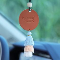 a car keychain with a tassel hanging from it