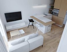 a living room and kitchen area with white furniture