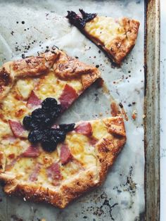 two slices of pizza sitting on top of a sheet of paper next to each other