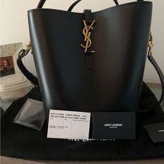 Brand New -Ysl Bucket Bag. Never Used -With Zipper Pouch Designer Bucket Bag With Branded Hardware, Luxury Bucket Bag With Branded Hardware In Tote Shape, High-end Bucket Bag For Evening, High-end Evening Bucket Shoulder Bag, High-end Evening Bucket Bag, Modern Black Bucket Bag With Branded Hardware, Designer Rectangular Bucket Bag With Branded Hardware, Modern Rectangular Bucket Bag With Branded Hardware, Modern Evening Bucket Bag With Branded Hardware