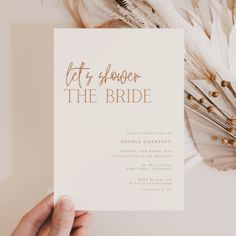 a person holding up a card with the words let's shower the bride on it