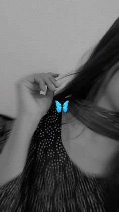 a woman with long hair and a butterfly on her back