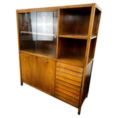 a wooden bookcase with glass doors and drawers