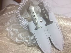 "**Notes** We have recently updated the knives to have heart shaped holes in the handle, same dimensions. Any gift messages with emojis will not print out correctly. This Steampunk Garter with Dual-Leather Knife Sheath and Knives comes in three colors--white, black, and brown. Lace patterns may vary. These garters are handmade in the United States and feature American leather, and authentic, full tang, and balanced throwing knives. Please be advised, these knives are real. They are sharp and can Thigh Knife Holster, Steampunk Knife, Knife Garter, Garter Aesthetic, Knife Holster, Knife Aesthetic, Thigh Holster, Pretty Knives, Steampunk Accessories