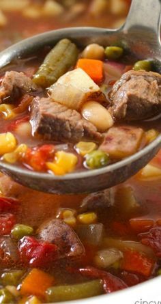 a spoon full of soup with meat and vegetables