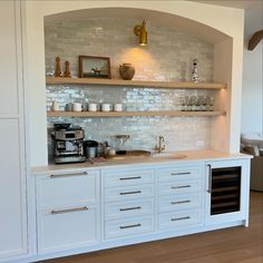 a kitchen with white cabinets and open shelves