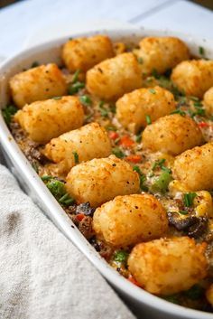 a casserole dish filled with tater tots and vegetables