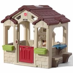 a toy house with a red door and brown roof