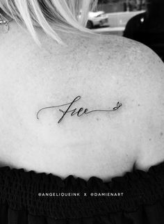 a woman's back shoulder with the word free written in cursive writing