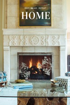 a living room with a fire place next to a poster on the wall above it