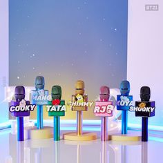 four microphones with the names of different tv shows on them in front of a backdrop