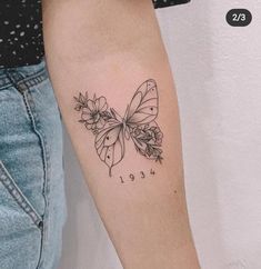 a woman's arm with a butterfly tattoo on the left side of her arm