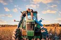 two people kissing on the back of a tractor