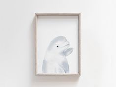 a white bird is in a frame on the wall