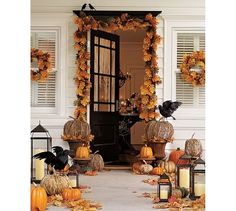 an entrance decorated for halloween with pumpkins and candles