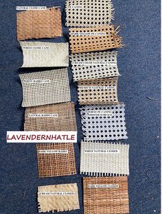 several pieces of woven material laid out on the ground with labels in front of them