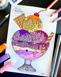 a drawing of an ice cream sundae on a table with markers and pencils