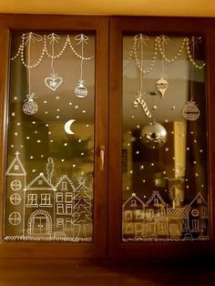 two glass windows with christmas decorations on them