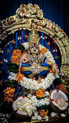 the idol is surrounded by flowers and other decorations