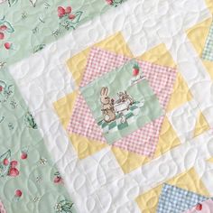 a quilted table topper with an image of a rabbit on it's back