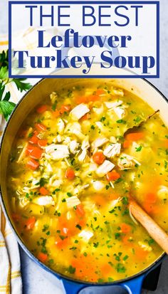 the best leftover turkey soup in a blue pot with a wooden spoon and parsley