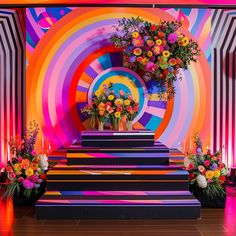 colorful floral arrangement displayed in front of multicolored backdrop with stairs leading up to it