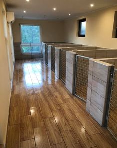 an empty room with several partitions on the wall and wood flooring in it