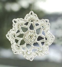 a crocheted ornament hanging from a window