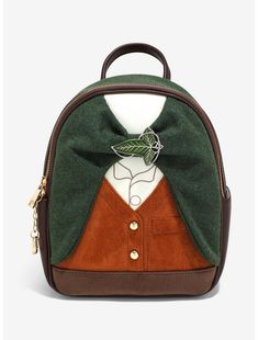 a green and brown backpack with a bow tie on it's front pocket, sitting against a white background