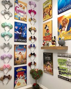 there are many posters on the wall with mickey mouse heads and other disney related items