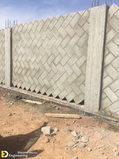 a concrete block wall being constructed in the desert