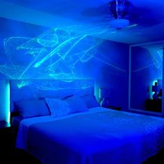 a bed in a room with blue lights on the walls