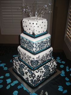 a three tiered cake with blue and white decorations