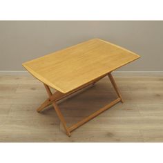 a small wooden table sitting on top of a hard wood floor