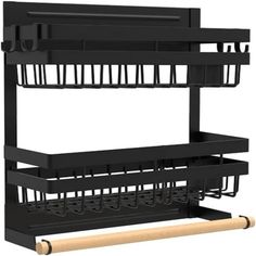 a black rack with three baskets and two rolling pins on the bottom one shelf is holding several items