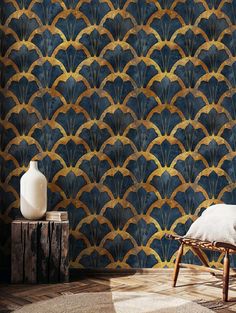 a room with a chair, vase and wallpaper on the walls in gold and blue colors