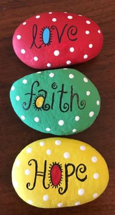 three painted rocks that say love, faith and hope