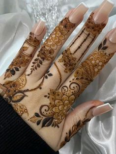 a woman's hands with hennap on it, and her hand painted