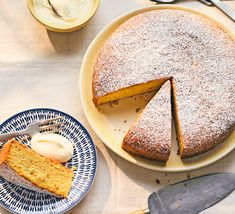 a cake on a plate with one slice cut out and the other half eaten next to it