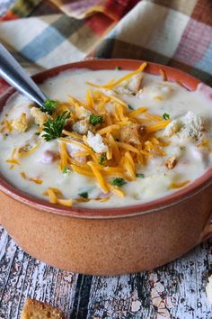 a bowl of soup with cheese and crackers