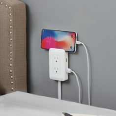 an iphone is plugged into the wall charger